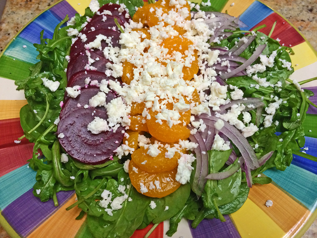 Salad with Beets, lettuce, mandarin oranges, red onions, and goat cheese.
