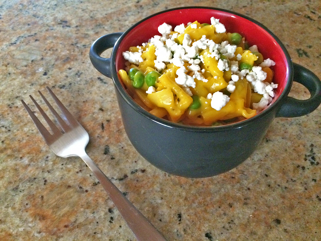 Boxed mac and cheese cooked with turmeric, peas, and goat cheese.