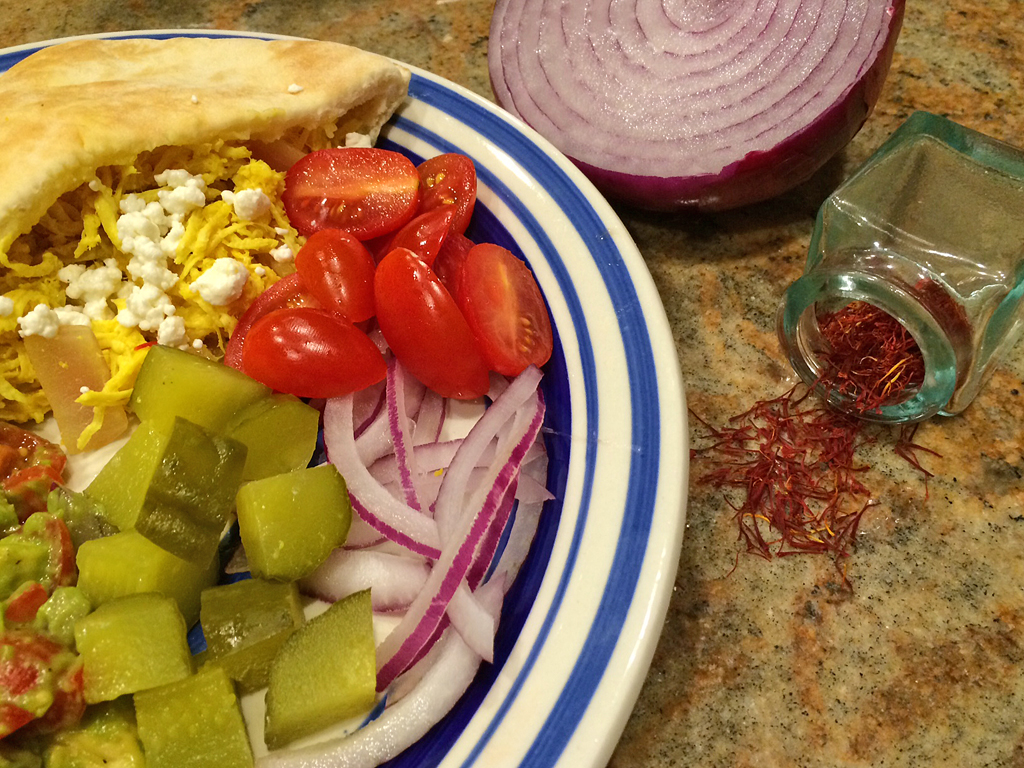 Saffron yogurt sauce tossed with shredded chicken on pita bread.