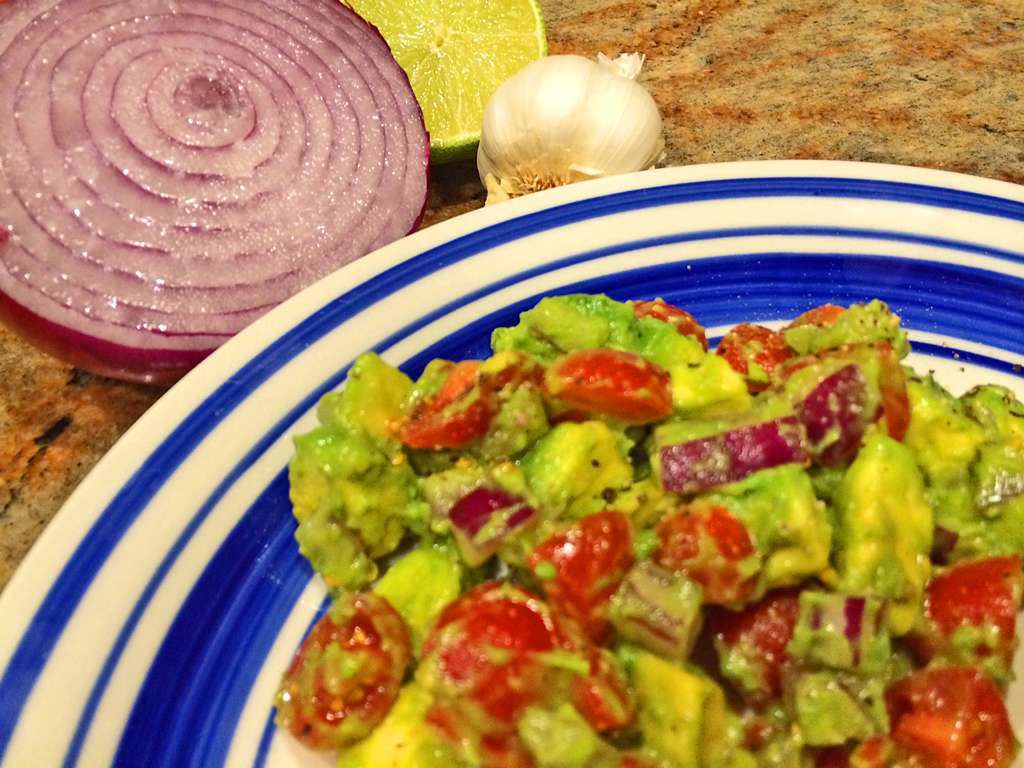 Avocado Cherry Tomato Salad with avocado, cherry tomatoes, and red onions.