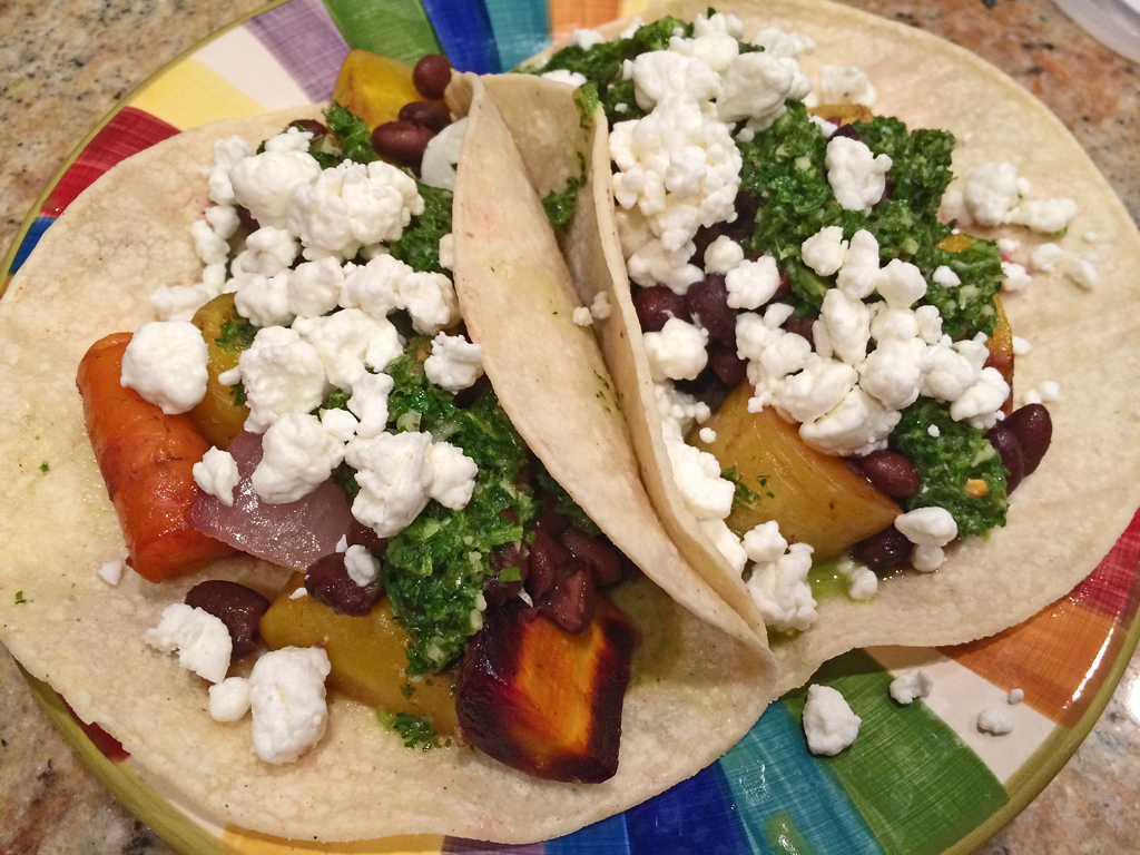 Black bean tacos with rainbow carrots and chimichurri sauce.