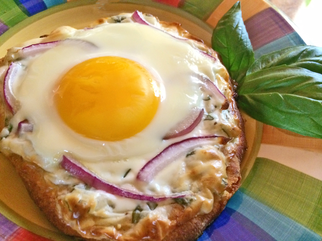 Homemade Breakfast Pizza with eggs, basil, and cream cheese.