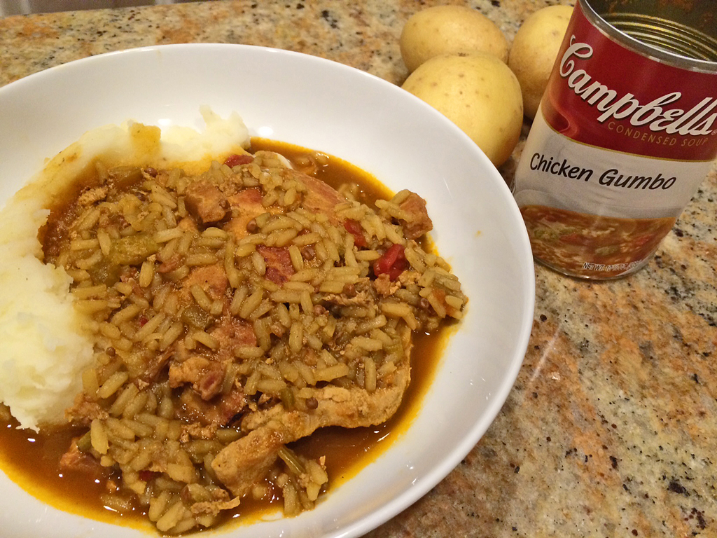 Pork Loin Steaks on mashed potatoes with gumbo rice gravy.