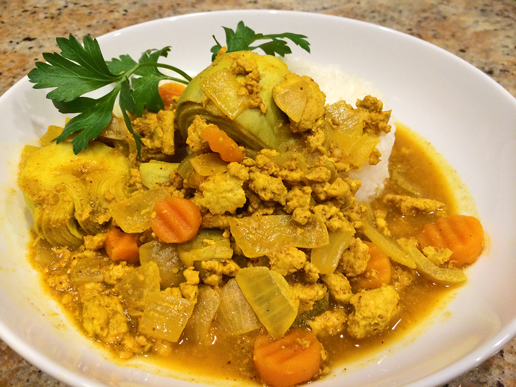 Chicken Moroccan stew with artichoke hearts atop white rice.