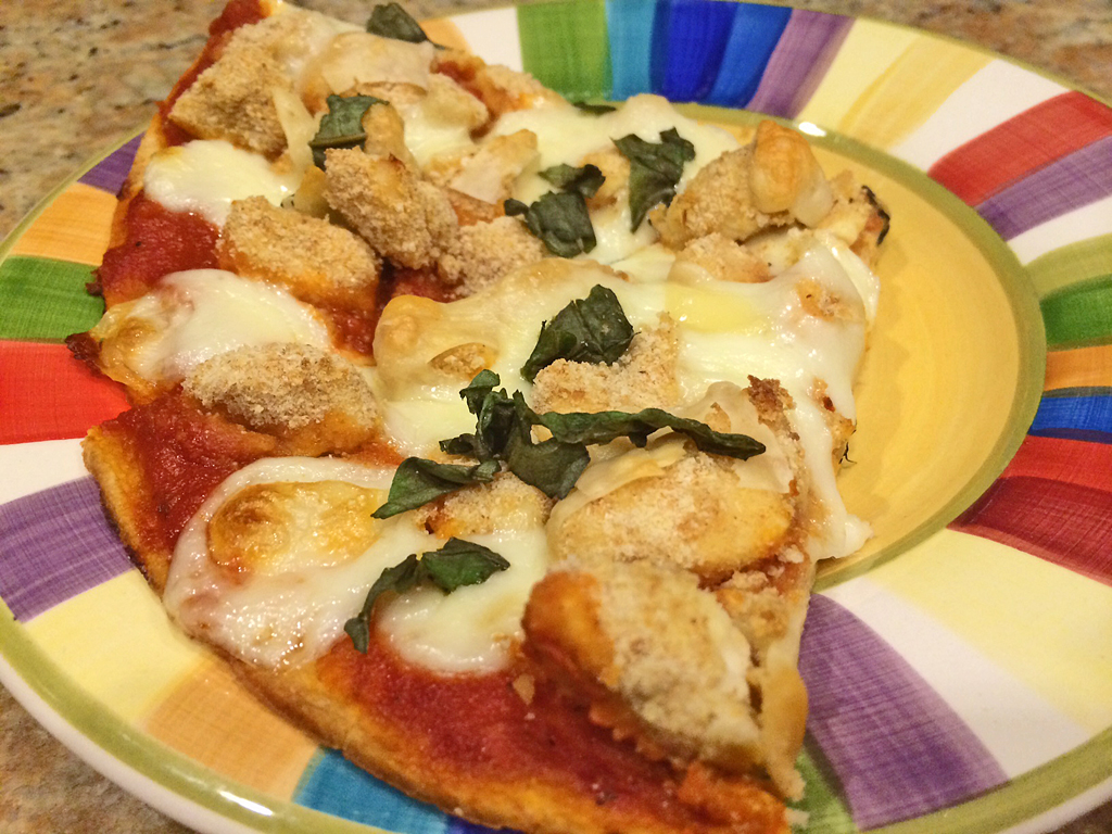 Parmesan Chicken Pizza Toppings including crusted chicken, basil, and cheese.