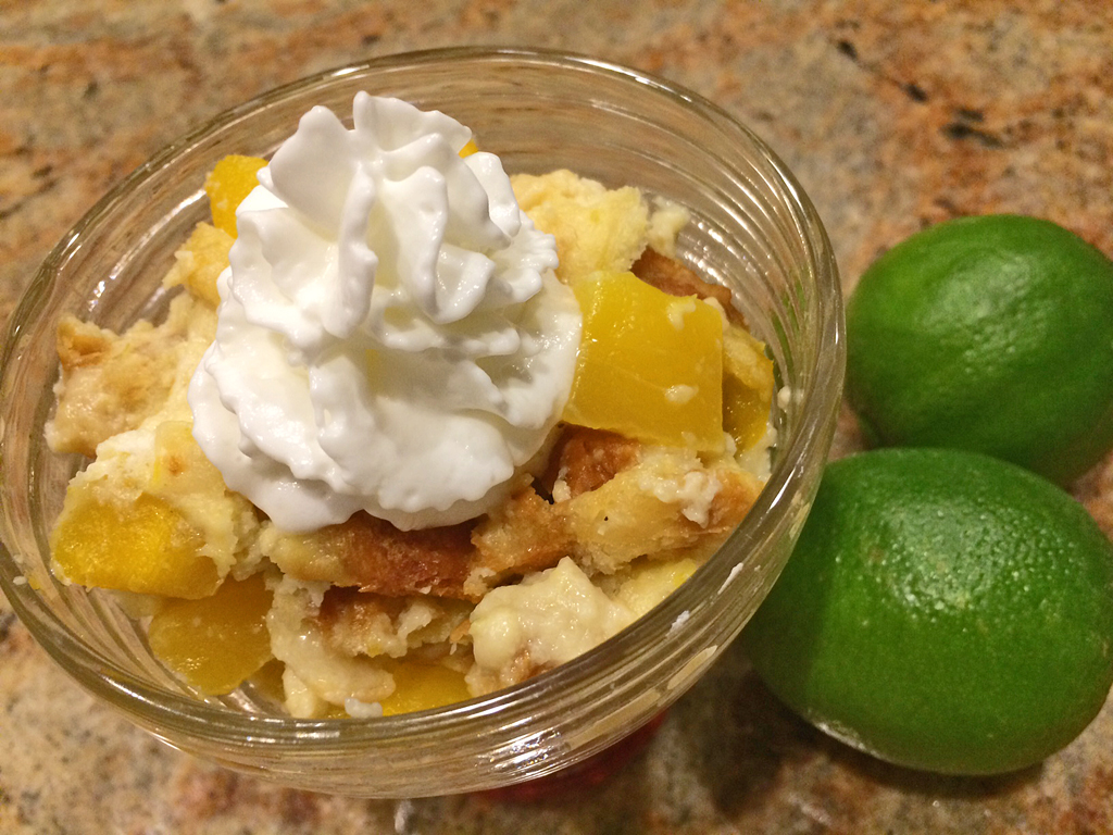 Tropical Bread Pudding for Two with mago, limes, and whipped cream.