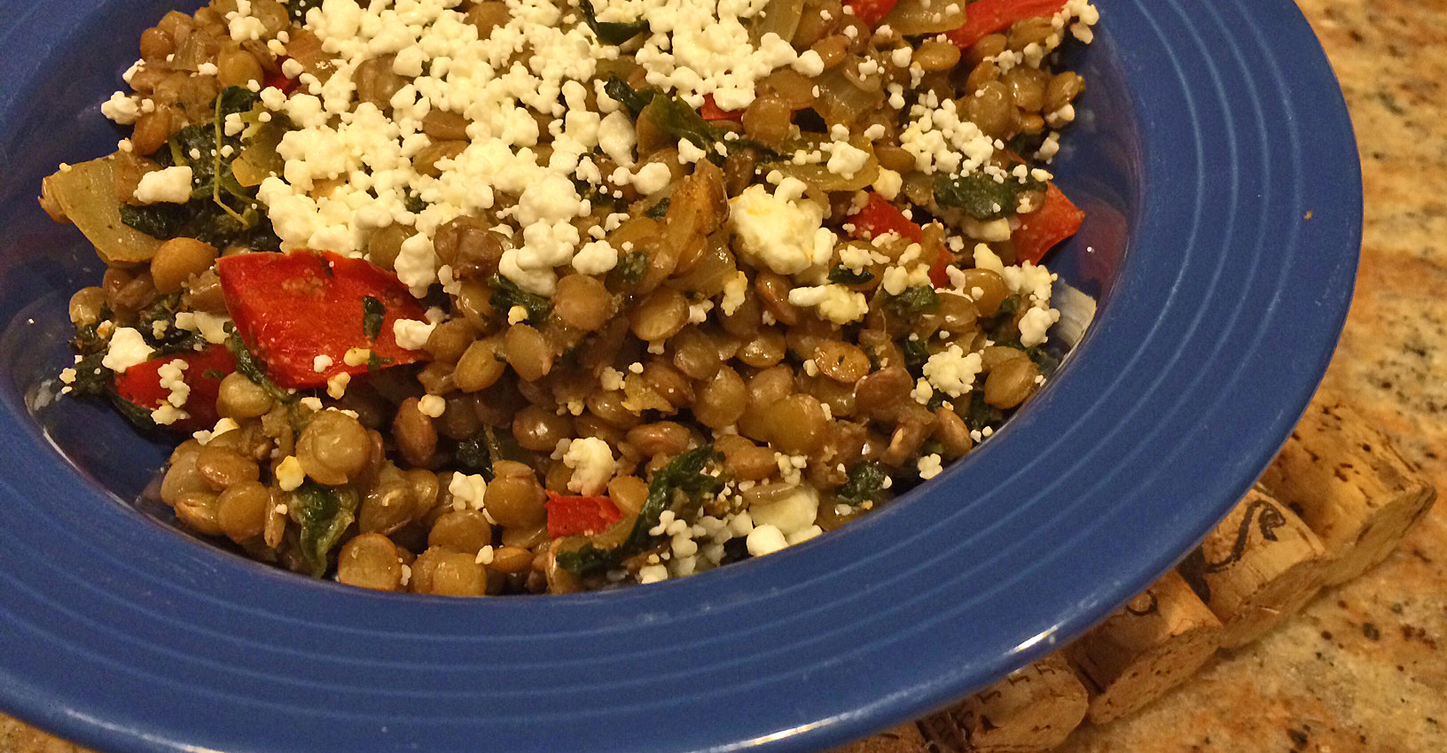 Lentil casserole with goat cheese, tomatoes, and spinach.